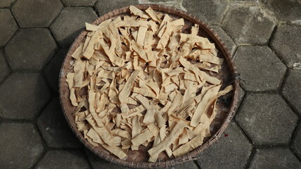 slondok in woven bamboo is being dried, slondok original food from Indonesia made from shredded...