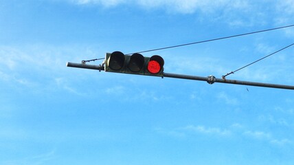 View of traffic light in city with blue sky background