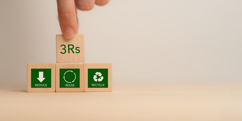 3Rs Concept. Reduce, Reuse, Recycle. Hand placing wooden block labeled "3Rs" representing sustainability: Reduce, Reuse and Recycle. Environmental responsibility and waste management.