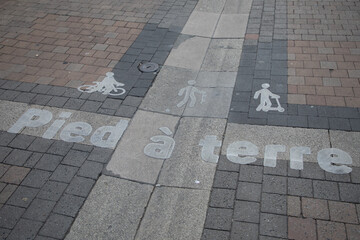 Bicycle scooter paint street sign pied a terre french text means cyclists skater on the ground...