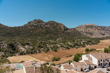 General plan of the fields, mountains, clear sky and houses of an Andalusian village in southern Spain.
