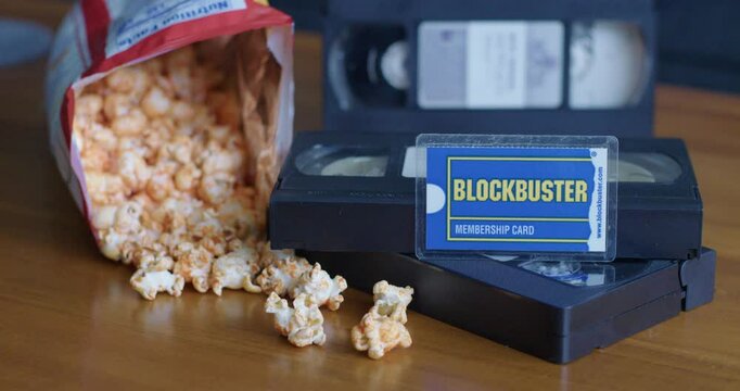Wide Pan Right Shot of a Blockbuster Membership Card with VHS Tapes