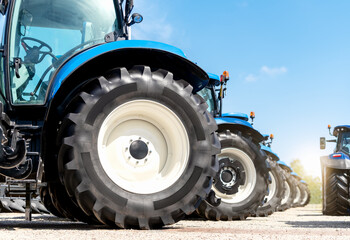 Agricultural equipment dealership background. Row of farm tractors low view