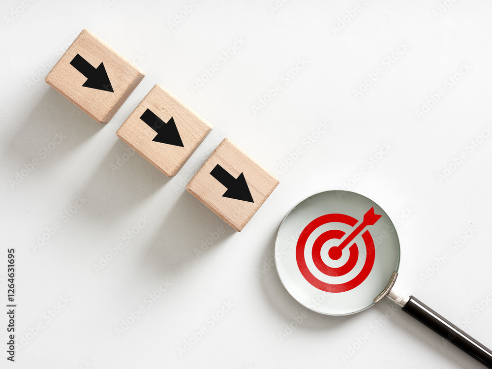 Poster magnifying glass focusing on target with wooden blocks and arrows pointing towards it