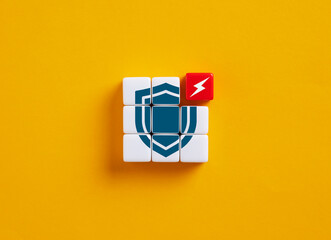 Lightning bolt attacking shield symbol formed with toy cubes