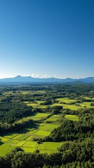 Serene Rural Landscape with Lush Fields and Majestic Mountains