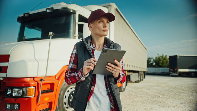 Focused Caucasian woman using tablet device. Reading notification or message from someone on screen. Thinking about best reply. Trucker spending time off road. Socializing remotely.
