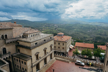 Obraz premium Ancient architecture of San Marino with stunning views over the countryside under a cloudy sky