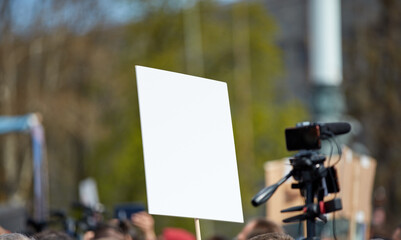 Protesters holding placards and signs on the streets.