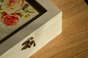 vintage-style wooden jewelry box with a floral design and a metal latch texture romantic aesthetic...