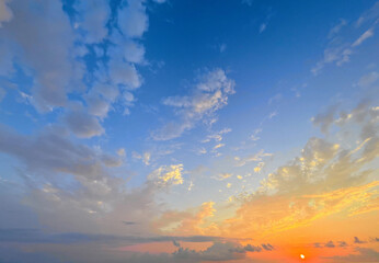 Weather background, sky with clouds. Blue summer sky background with sunset sun