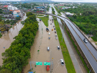 Songkhla,Thailand - 28 Nov 2024: Aerial view of floodwaters inundate roads and vehicles after heavy...