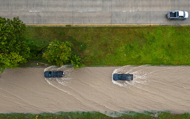 Songkhla,Thailand - 28 Nov 2024: Aerial view of floodwaters inundate roads and vehicles after heavy...
