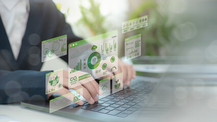 Businessmen use laptops to analyze ESG Co2 Carbon footprint Emission report graph to net zero....