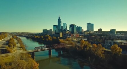 Naklejka premium Downtown Nashville Aerial: City Skyline with River Bridge and Pedestrians
