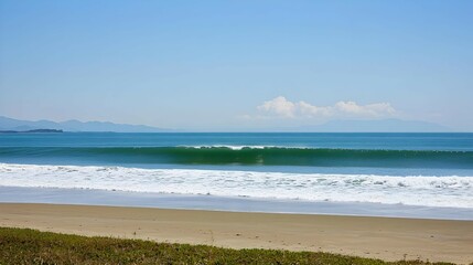 Serene Coastal Landscape: Blue Ocean Waves Rolling onto Sandy Beach Under Sunny Sky