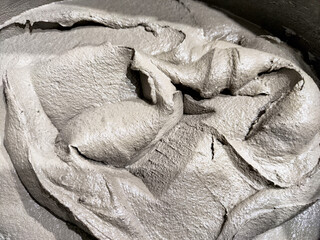 Indoor tile repair and installation work using adhesive and gray cement mixture in a construction...