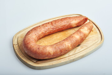 homemade poultry sausage lying on oak board, top view