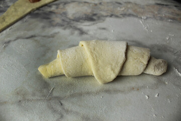 Raw croissant of raw puff pastry close-up. Homemade cakes