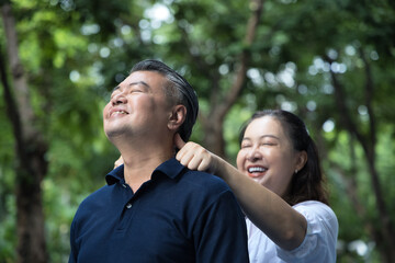 Middle aged woman therapist doing acupressure at uncle man Fengchi, Gallbladder Meridian GB20 trigger point, concept of alternative medicine, Traditional Chinese Medicine, TCM therapist