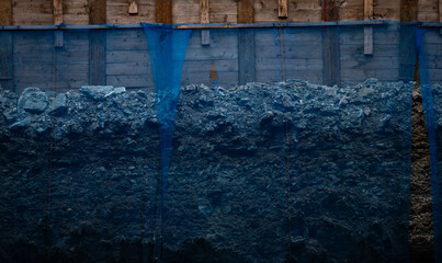 Blue construction rubble and debris holding net at job site in cold winter day