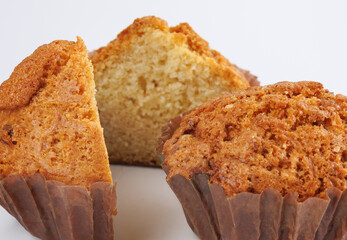 Cupcake in a paper cup on a white background.
