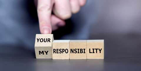 Hand turns cube and changes the expression 'my responsibility' to 'your responsibility'.
