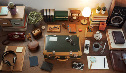 Vintage style desktop and packed suitcase