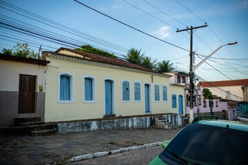 Colorful colonial houses on cobblestone street.