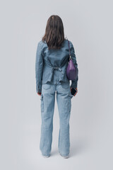 Portrait of a young woman standing back view