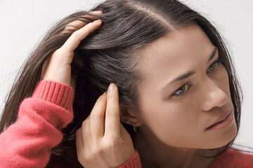 Young woman checking her hair