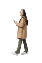 Woman holding her smartphone and walking