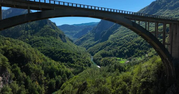 Durdevica Tara Bridge Over The Tara River With Mountains Covered In Green Forest In Montenegro. - aerial shot