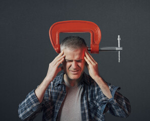 Stressed man with a clamp on his head