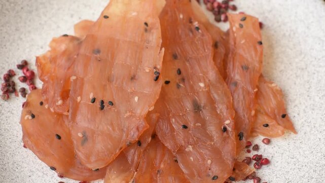 Jerky, dried chicken meat with salt and spices on a dark concrete background