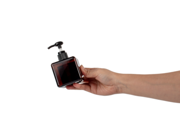 Cosmetic bottles made of dark amber glass in hand on transparent background