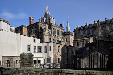 Historic Edinburgh architecture under blue sky.