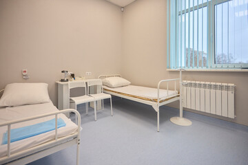 A Hospital Bed located within a Medical Facility designed for patient comfort and care