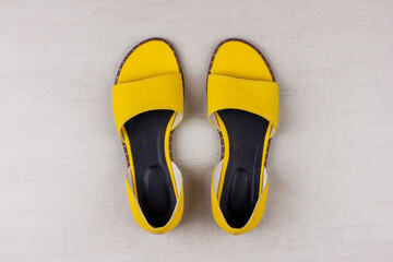 yellow women's summer sandals on a gray background top view