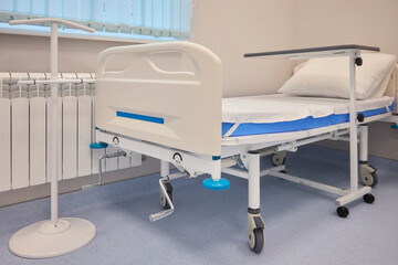 A Hospital Bed located within a Medical Facility designed for patient comfort and care