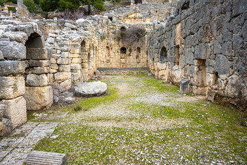 Remains of gymnasium in acnient Lycian city Arycanda. Ancient city on mountain near Aykiricay village.Well preserved semi-circular theater of Arycanda, ancient Lycian city in Antalya