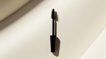 a single, luxurious mascara wand, its bristles full and luscious, resting diagonally on a solid, creamy white background