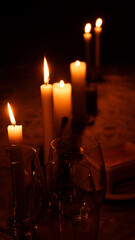 Candles and wine glasses in the dark
