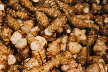 Group of fresh jerusalem artichokes background. Jerusalem artichokes or sunroot or sunchoke. Vegetarian food. Close-up, top view