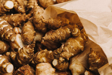 Group of fresh jerusalem artichokes in a paper bag. Jerusalem artichokes or sunroot or sunchoke....