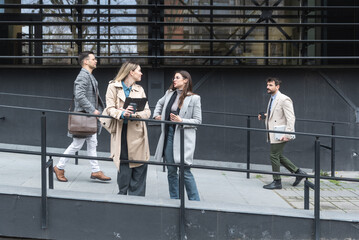 Professional occupation, office workers. Business people meet before staff meeting and presentation in office building, to talk and discus plans and tactic of speech theme. Finance and economy.