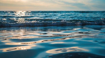 Calm ocean surface with gentle waves reflecting sunlight in the early evening sky Copy Space