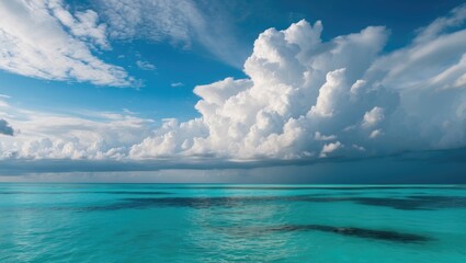 Tropical seascape with clear turquoise waters under a dramatic sky filled with fluffy clouds and sunlight reflections, Copy Space