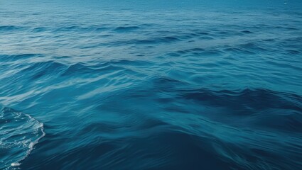 Blue ocean water surface with gentle waves, peaceful marine scene highlighting texture and depth, suitable for backgrounds, Copy Space.