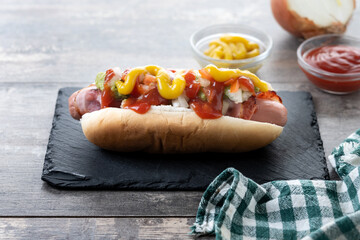 Sonoran hot dog. Traditional Mexican hot dog on wooden table